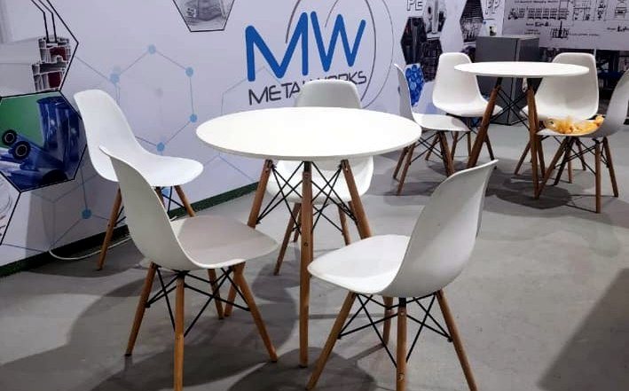 White wire cocktail tables and lounge sofa in a venue lobby