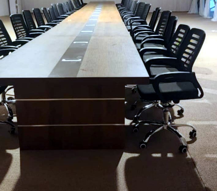 Conference room prepared with executive office chairs around a meeting table