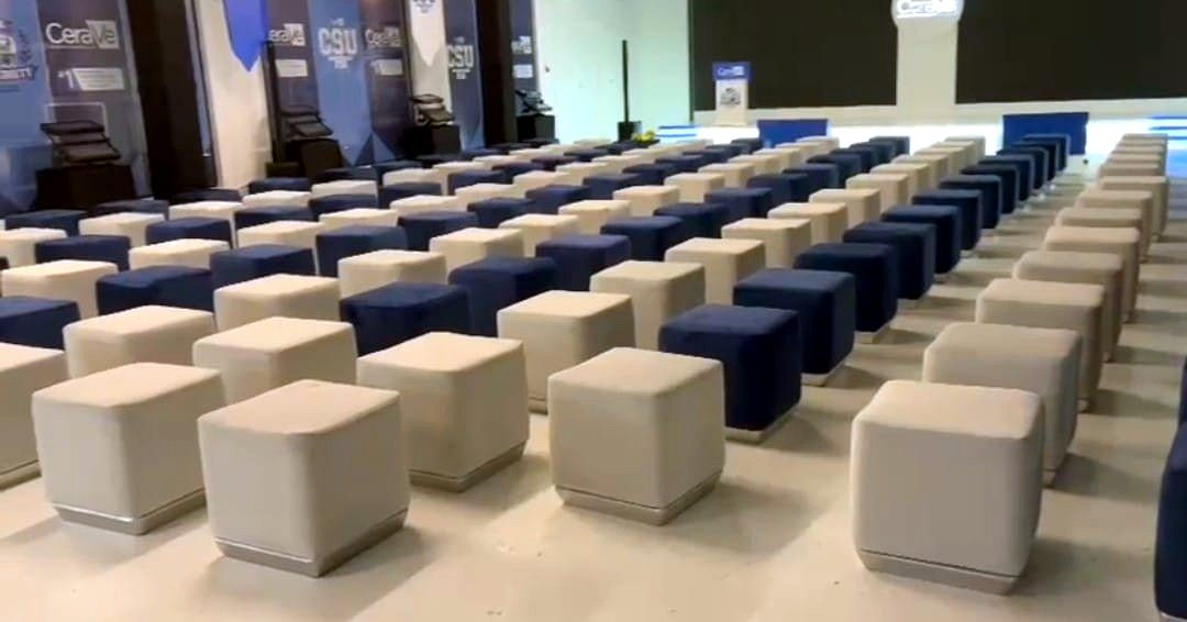 Rows of cream and navy pouf cube seats arranged for a product launch